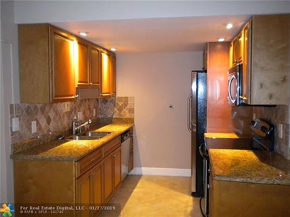 UPDATED KITCHEN WITH GRANITE COUNTERS AND WOOD CABINETS