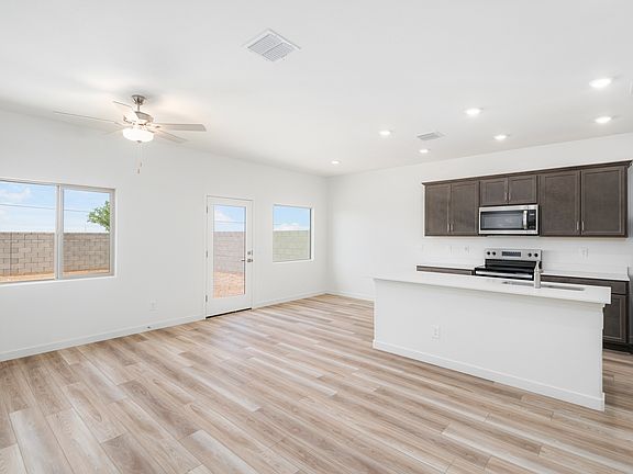 The living area is filled with natural light from large windows creating a warm environment.