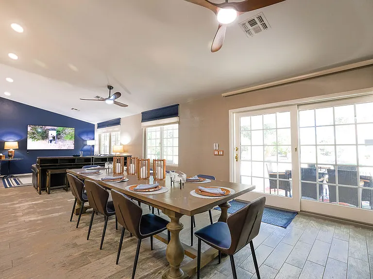 Open plan living room, dining room, kitchen, entry way.
Living room has 2 leather couches with queen size hide away bed, dining table seats 10, sliding door to patio seating