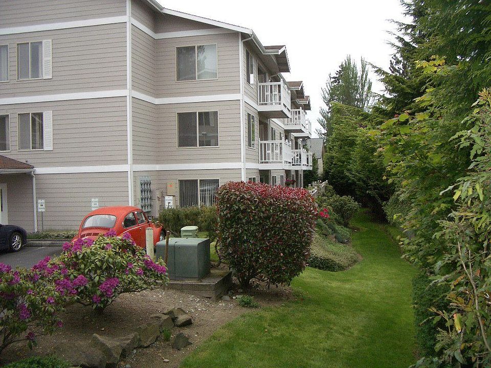 Unit is on 2nd floor, above red shrub in photo