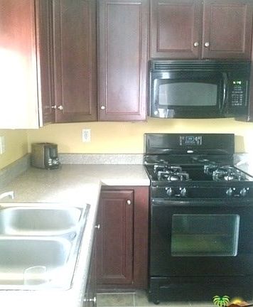 Remodeled kitchen with newer cabinets and new tile