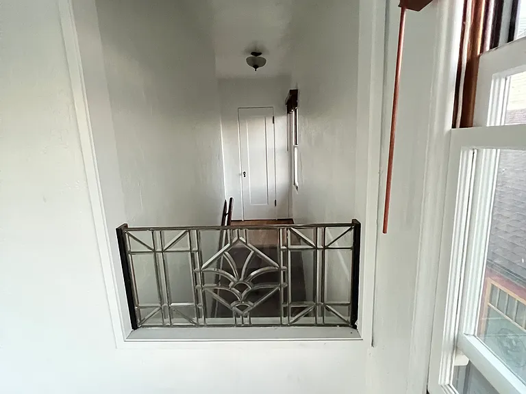 view of second floor landing and extra closet from porch