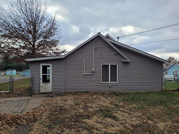 rear view of the home from inside of the fenced in yard