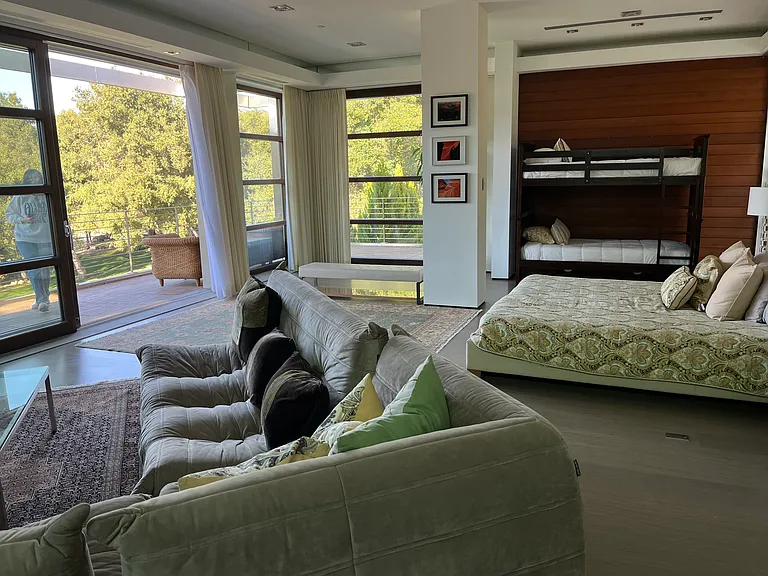 seating area in master bedroom with lbig screen tv and gas fireplace