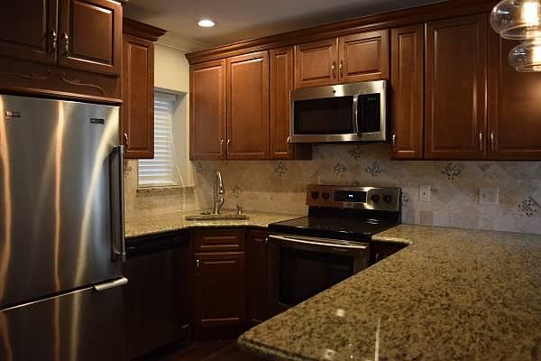Custom kitchen with granite countertop and marble backsplash