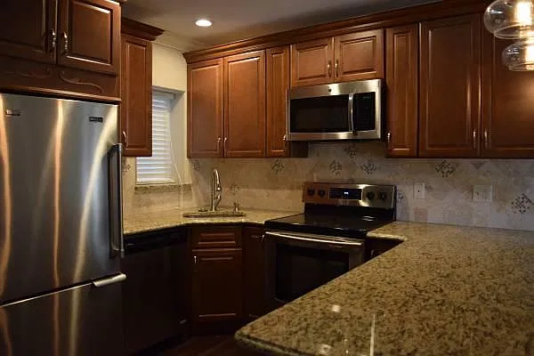 Custom kitchen with granite countertop and marble backsplash