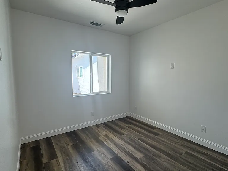 Bedroom 1 or office with ceiling fan and remote.