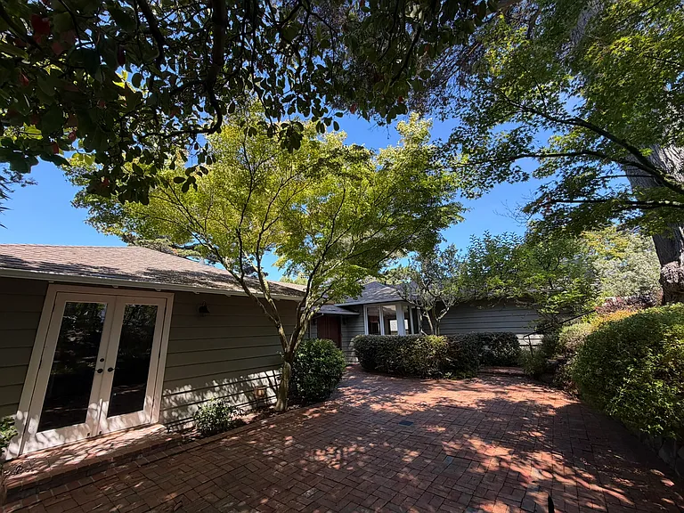 Large patio, french doors lead to bedroom/office. Window at back is kitchen sink windows.