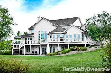 Mature trees and landscaping with a large circular drive.