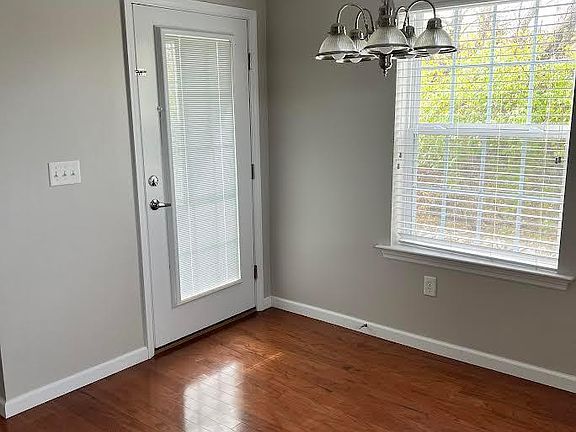 Eat-in kitchen with continued hardwoods and patio access