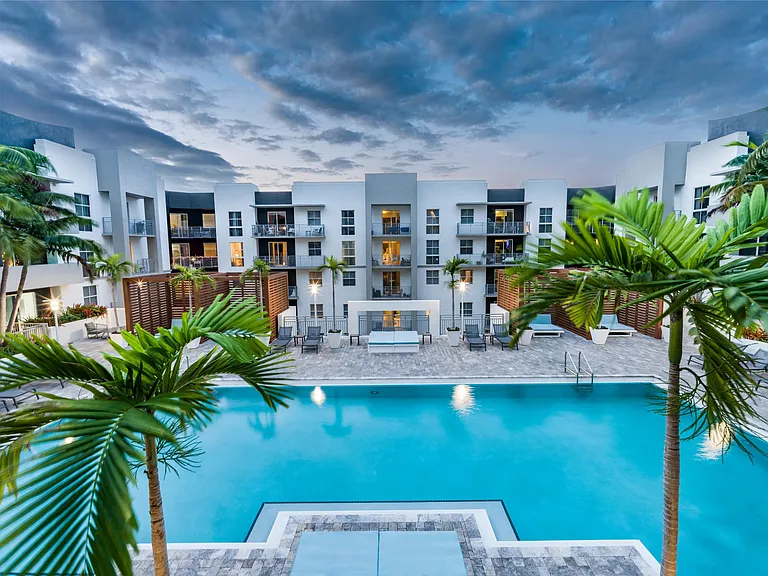 Hotel-inspired pool at Modera Douglas Station in Miami, FL including sundeck with cabanas.
