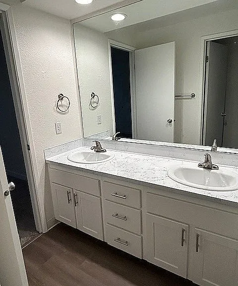 Explore elegance and functionality with this beautifully designed bathroom featuring a dual vanity.