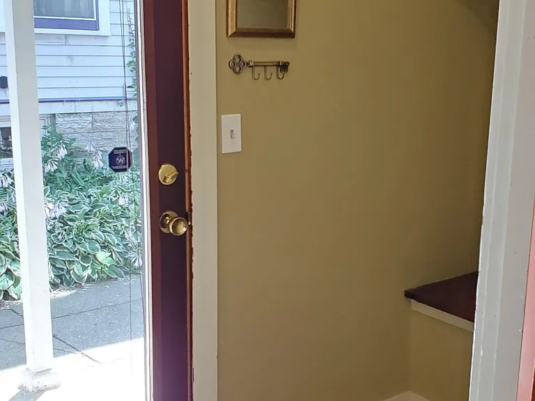 The light filled side entrance has ample storage for coats and shoes.