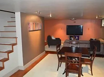 Basement entertainment center. TV not included. Before move-in, preparing to repaint basement to a lighter/brighter white tone.
