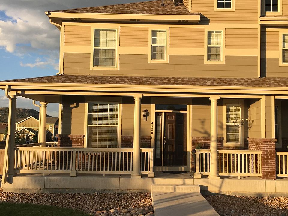 End unit with wrap around porch.