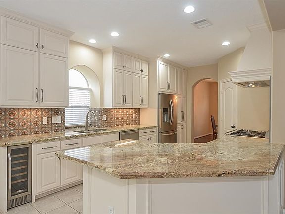 There are SO many cabinets and SO much wonderful counter work surface!! Note the breakfast bar.