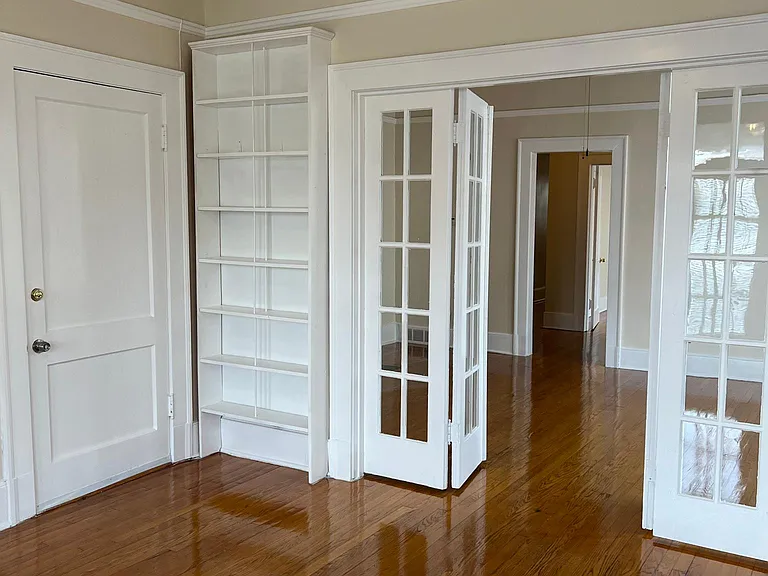 Office view #1 / potential 3rd bedroom. Built in book shelves. French doors lead in from den. Front door leads to inside stairwell to exterior building front door!