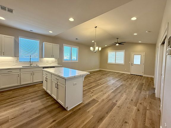 Open floor plan - kitchen, dining area, living room.