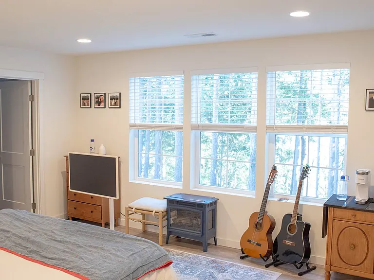 Primary bedroom overlooking back yard, trees & water views