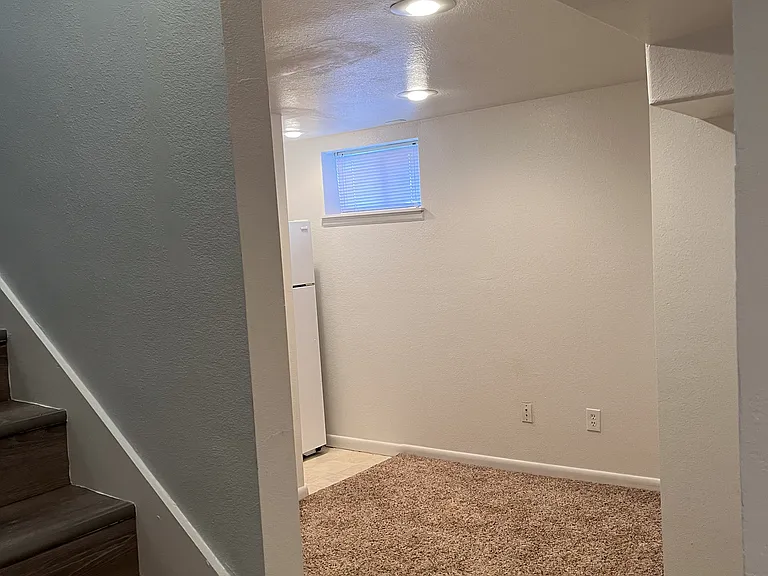 Den with fridge next to bedrooms C and D.