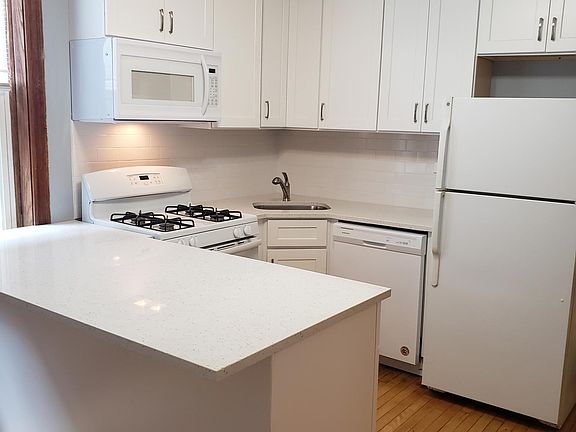 Brand new kitchen with shaker style cabinets, quartz countertops, new appliances.