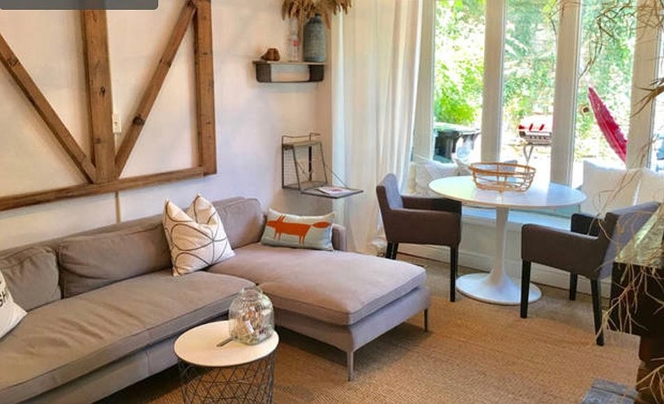 Chic, hip living space with large windows and ample natural