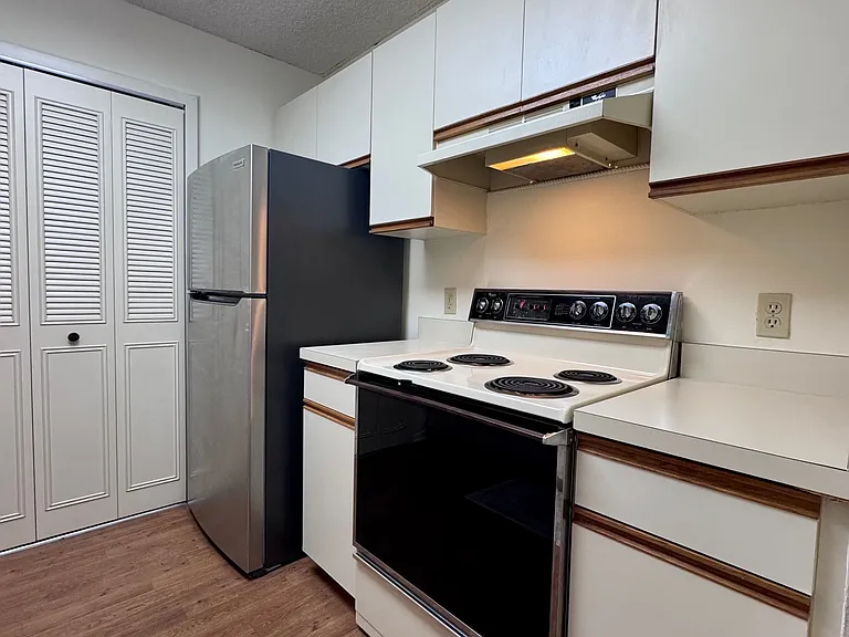 Kitchen w/ pantry and stainless steel fridge