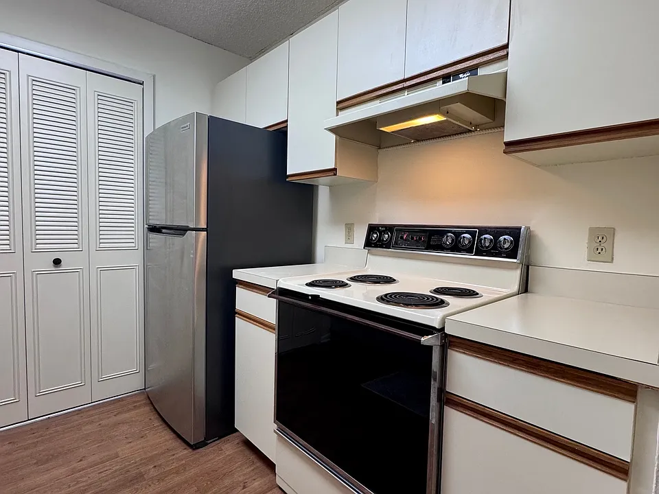 Kitchen w/ pantry and stainless steel fridge
