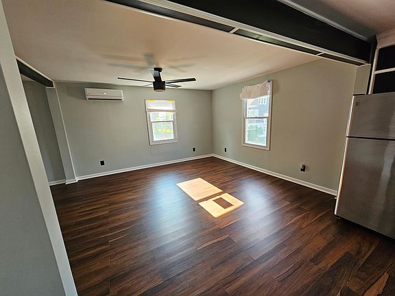 Living Room/Dining Room with Mini Split AC with heat pump. Ceiling fan with remote control.