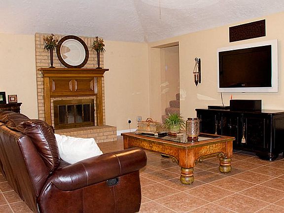 Living area features wood burning fireplace with gas starter