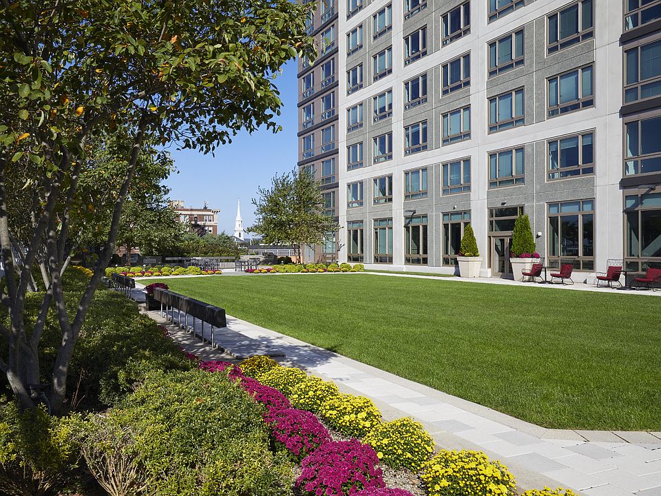 An enchanting outdoor green space awaits, offering a tranquil respite amidst the bustling cityscape