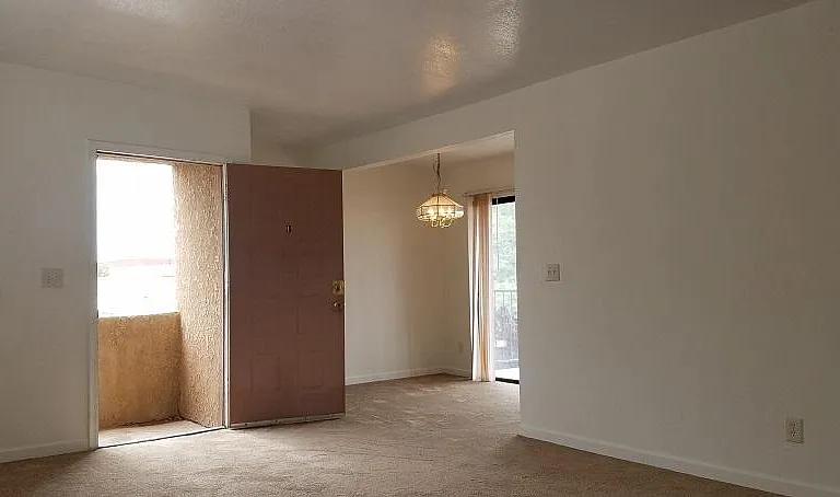 Living room toward front door. Dining room beyond.