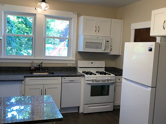 Kitchen 
granite counter top, gas range, microwave, & dishwasher