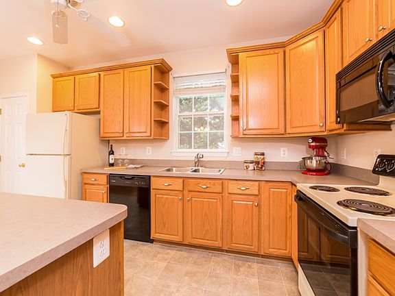 Semi-updated kitchen with center island, oak cabinets and recessed lighting