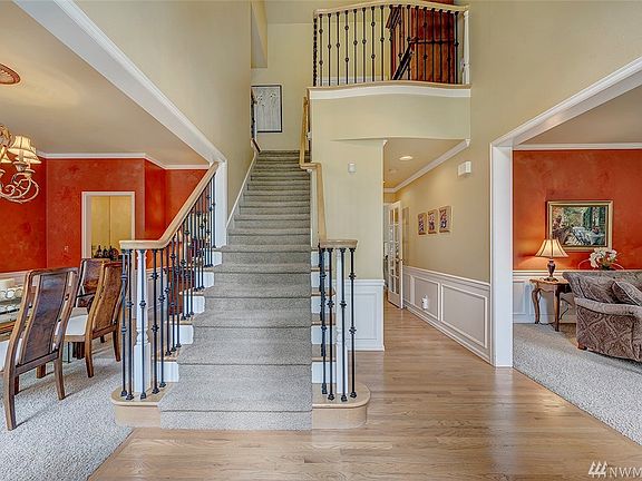 Beautiful Hardwood Floors, Classis Wainscoting, And A Wrought Iron Staircase Welcomes You Upon Entering The Home.