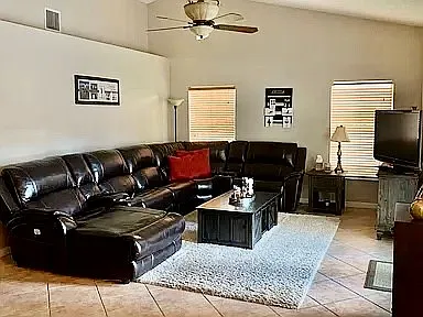 open concept great room adjoining kitchen with french doors to pool