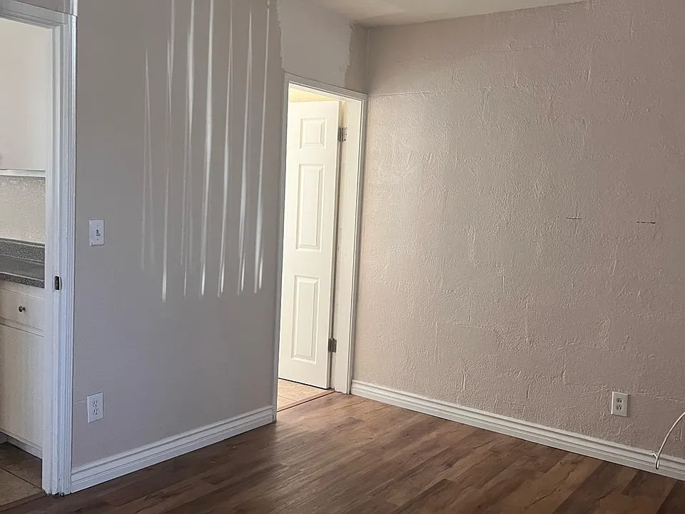 Bedroom with ceiling fan and wood floor
