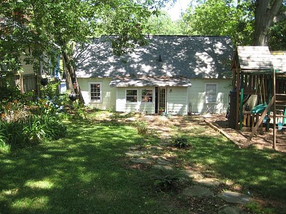 Large shaded backyard with privacy fence