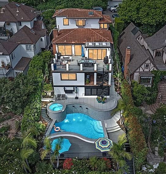 This unique estate features a cascading salt water pool and spa, and multiple outdoor spaces including a private guests cabana, large main deck and pool area decks with two outdoor TV's.
