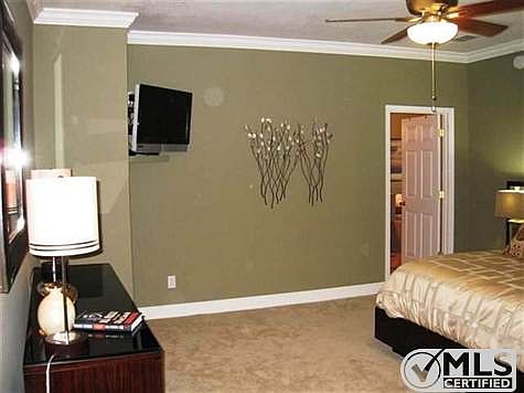 Sophisticated Master Bedroom with crown molding and oversized walk-in closet.