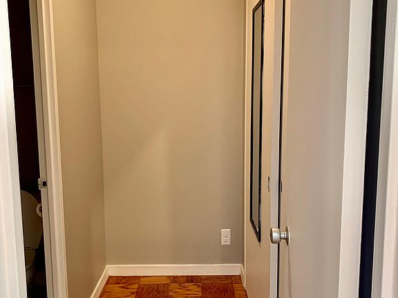 Door leading to bathroom and two spacious closets