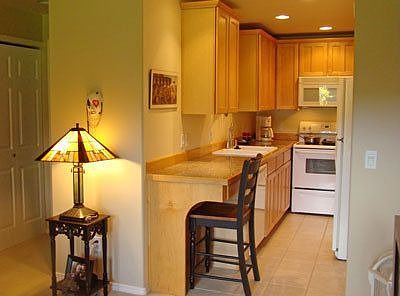 Kitchen has tile floor, maple cabinets, granite tile counters, recessed lighting, pantry, and desk