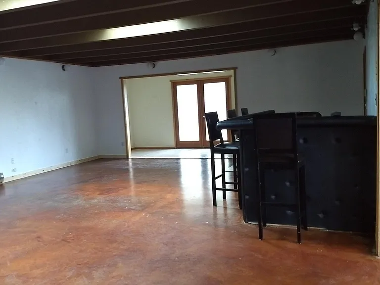 Large recreation room with double doors to the front yard