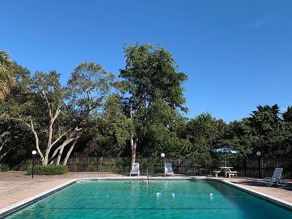 Main Pool area surrounded by nature and canal