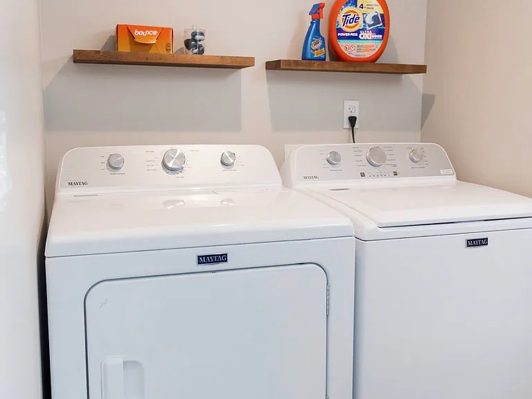 Washer dryer, located in primary bathroom.