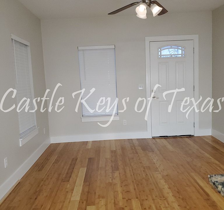 Living Room view from kitchen showing the front entry door.