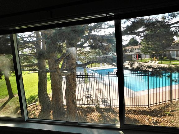 view of pool from picture window