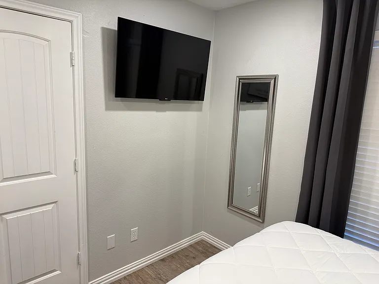 Bedroom 2 - a queen bed and smart tv.