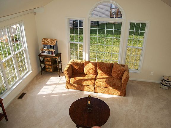 Sunlit formal Living Room with cathedral ceiling.