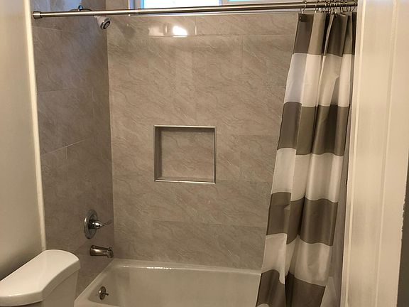 Newly updated hallway bathroom with brand new bath, toilet, sink, and fixtures.